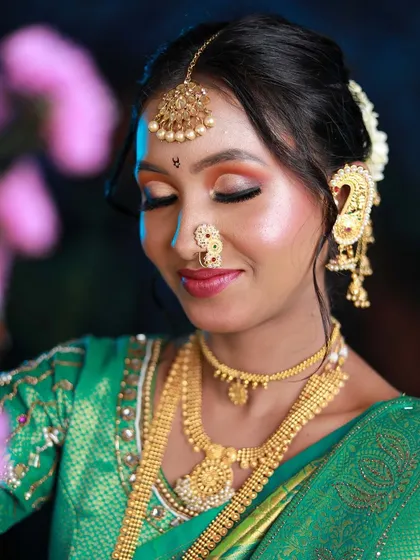 A photo of a Maharashtrian bride look taught to a new batch, featuring a green saree and vibrant eye makeup.