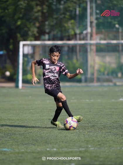 A player shows great dribbling form and balance on the field.