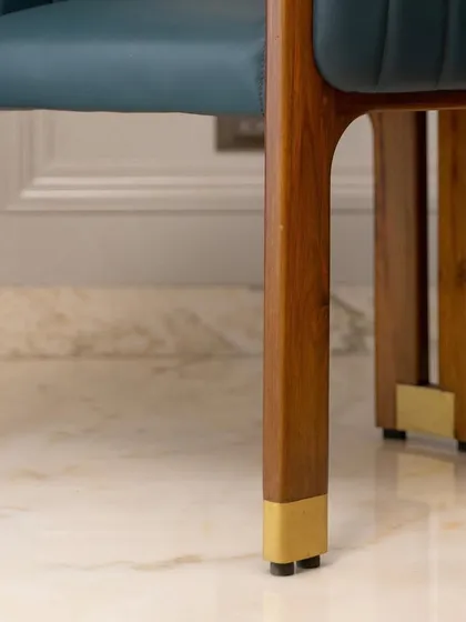 The legs of this accent chair feature custom brass caps, a small detail that adds a significant touch of luxury. It's this attention to the finer points that defines my work.