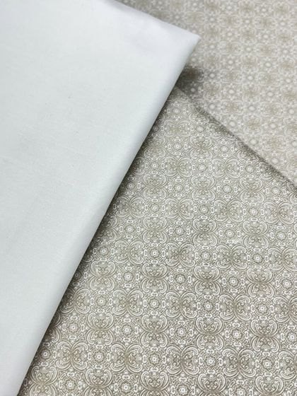 This is a subtle, elegant printed fabric for a kurta izaar set. The intricate pattern in a neutral color makes it a versatile choice for many occasions.