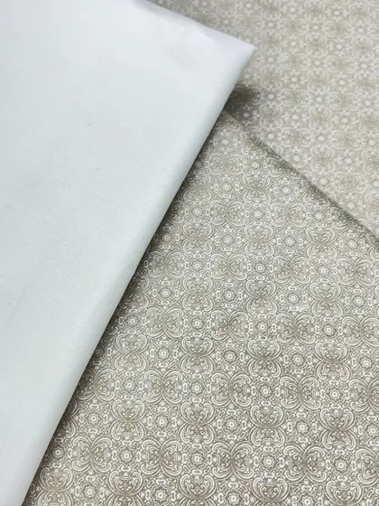 This is a subtle, elegant printed fabric for a kurta izaar set. The intricate pattern in a neutral color makes it a versatile choice for many occasions.