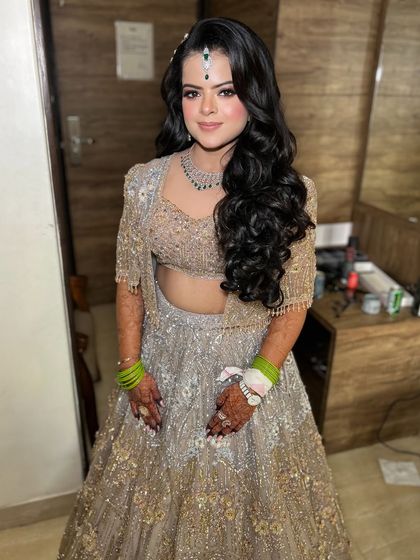 The full look for this engagement bride. The silver and gold lehenga is perfectly complemented by the glamorous makeup and hair.
