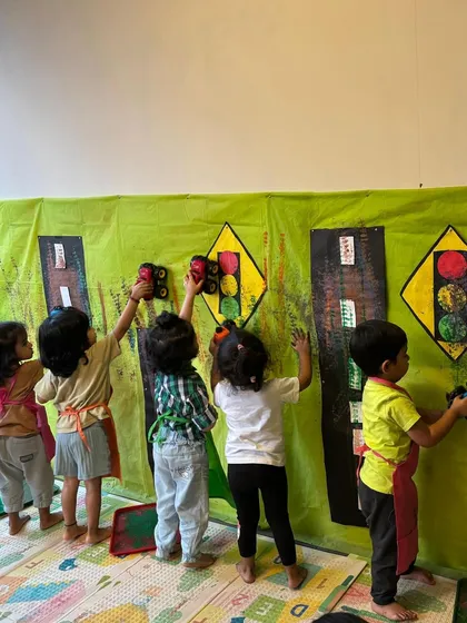 Teamwork makes the dream work! In our transport-themed week, these little artists worked together on a giant wall mural, painting traffic lights and roads. It's a great way for them to learn collaboration while having creative fun.