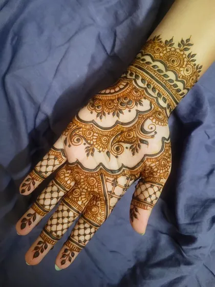 A beautiful henna design perfect for Eid or any celebration. The pattern flows gracefully from the wrist to the fingers, with a mix of paisleys and floral elements.