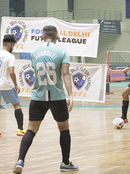 Players in action during a Football Delhi Futsal League match. The clear court markings and excellent lighting ensure a fair and competitive game.