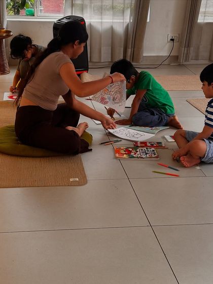 An instructor guides young students through a creative mindfulness activity, fostering a calm and focused environment even after the physical practice is over.