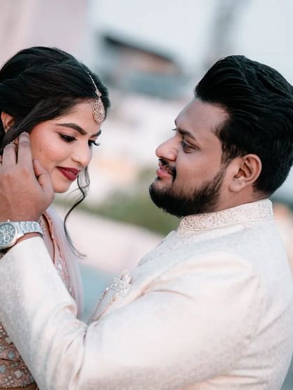 An intimate pre-wedding portrait where the groom-to-be gently caresses his partner's face, full of warmth and affection.