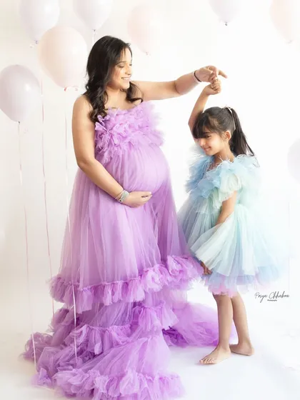 A dance between a mother and her firstborn, waiting for the new arrival. Including siblings in your maternity shoot is a beautiful way to capture the growing love and excitement of the entire family.