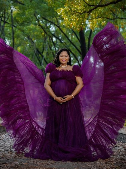 Feel like a butterfly in this incredible purple trail gown. The fabric is designed to be tossed for a "flying wings" effect, creating a truly magical and unforgettable photo.