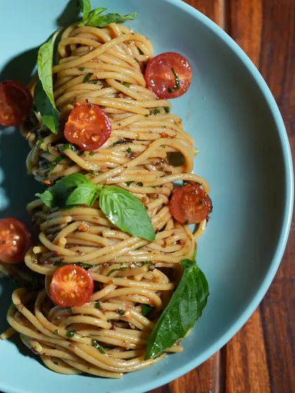 A classic dish made with love. My Aglio Olio pasta is a simple, soulful meal, tossed with garlic, olive oil, fresh basil, and cherry tomatoes for a taste of pure comfort.