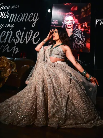 A full-length shot of Sushant Divgikar's stage look. The dramatic pose showcases the flow of the lehenga and the power of the glamorous makeup.