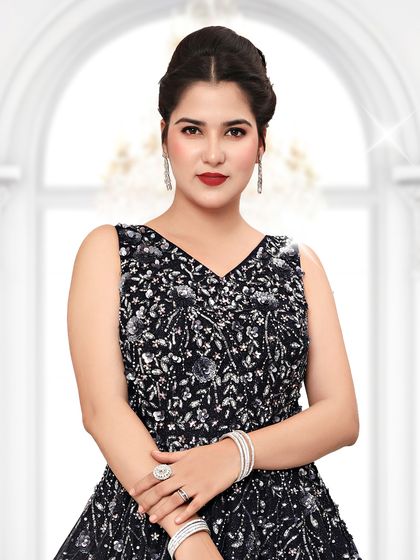 A close-up of our sleek black reception gown. The detailed bodice and elegant silhouette are designed to make a sophisticated statement.