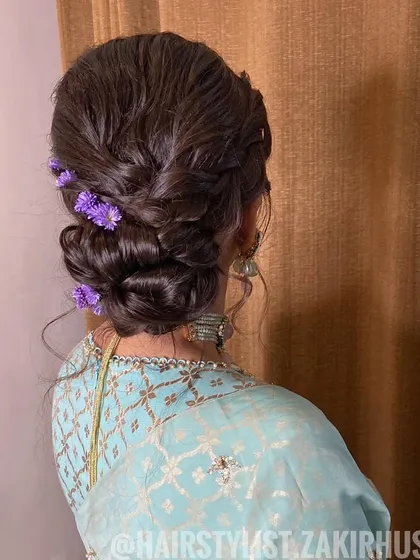 A side view of the purple floral bun, demonstrating its soft and romantic silhouette.