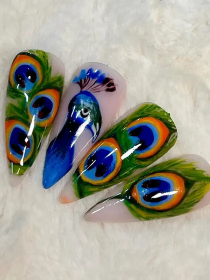 This incredible peacock and feather nail art was created by one of my talented students. It showcases advanced painting techniques and a great eye for detail.