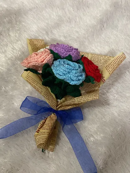 A little rainbow in a bouquet. This mini arrangement features roses in multiple colors, wrapped in newspaper for a cute and quirky gift.
