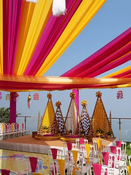 Another wide-angle view of the Haldi venue, showing the full scale of the decor against the beautiful open sky.