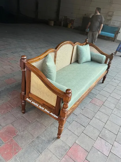 Side view of the colonial daybed with sage green upholstery.