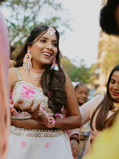 A candid shot of the happy Haldi bride, her hair in a simple and pretty style.