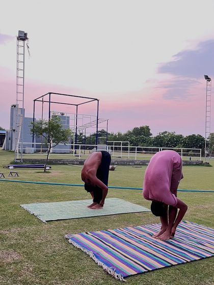 A deep forward fold (Uttanasana) helps to release the spine and hamstrings. We incorporate these essential stretches to improve flexibility and aid in recovery.