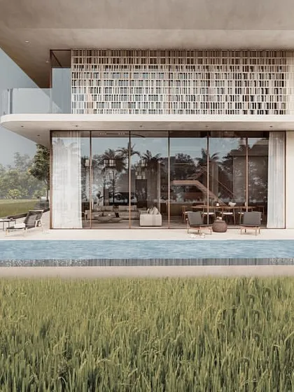 The infinity pool of a pavilion home is designed as a sharp edge of water that meets the soft texture of the paddy fields. This creates a seamless transition from the curated space of the home to the wildness of the surrounding landscape.