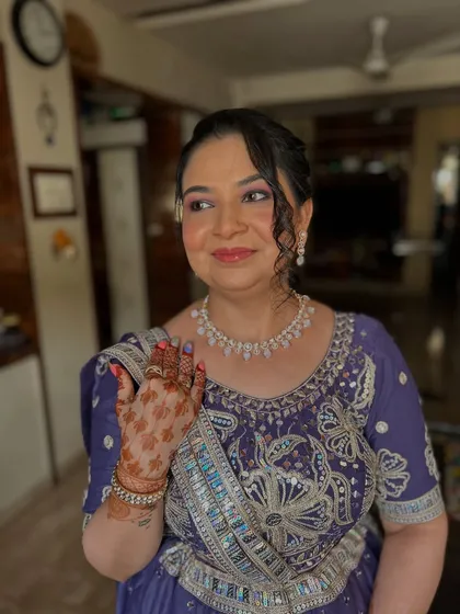 A happy, candid moment showing her henna-adorned hands.