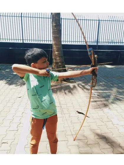 A young boy from the March batch, learning the fundamentals of archery.