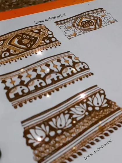 More practice with intricate border designs. These bands feature peacocks, elephants, and lotuses, perfect for adding detail to a bridal piece.