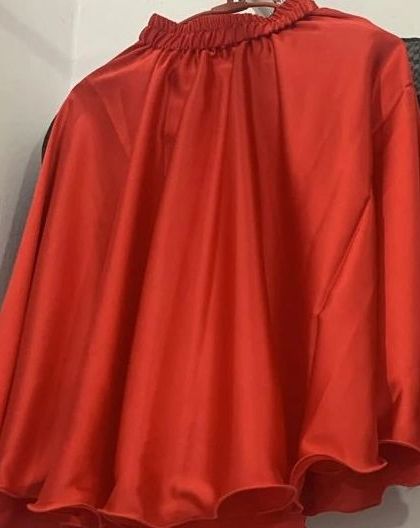 A simple yet vibrant red skirt, which can be paired with different blouses. This shows the kind of versatile separates I offer for custom outfits.