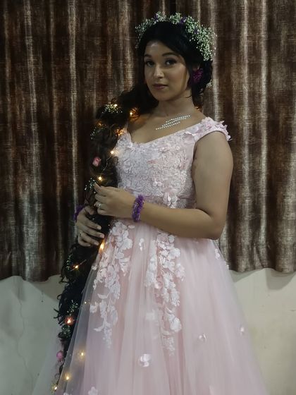 A closer look at the delicate details of this pink floral gown, perfect for themed parties or whimsical photoshoots.