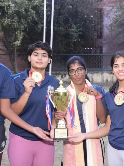NTC player Kashish Bhatia and her teammates celebrate with their trophy and gold medals after winning the All India University Games Tennis Tournament.