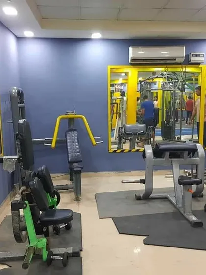 This area features several selectorized machines for chest and shoulder workouts. The large mirrors help you check your form and maintain proper technique during every repetition.