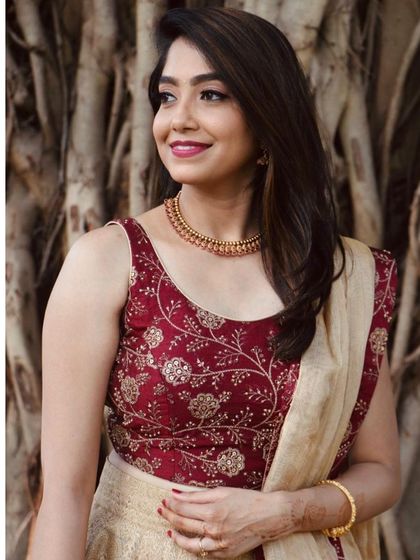 A lovely portrait showcasing the detailed embroidery on the blouse and the complementary soft makeup.