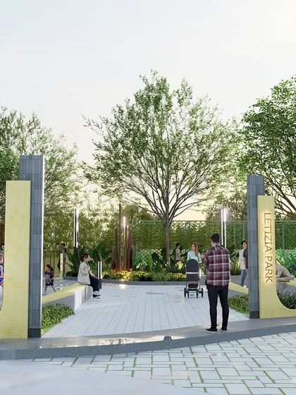 The entrance to 'Letizia Park', where bold yellow accent panels contrast with the concrete and surrounding greenery. The design creates a vibrant and cheerful identity for this community park, which is themed around happiness.