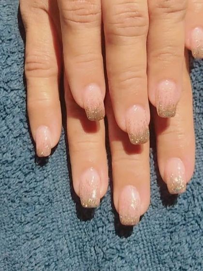 Another look at the nude and gold glitter French manicure, showing the sparkle under different light.