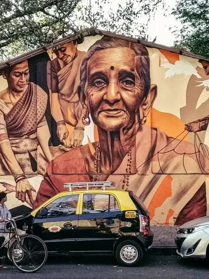 A sepia-toned mural that honors the women of the local community. The artwork beautifully captures the faces of generations, telling a story of life and legacy on a public wall.