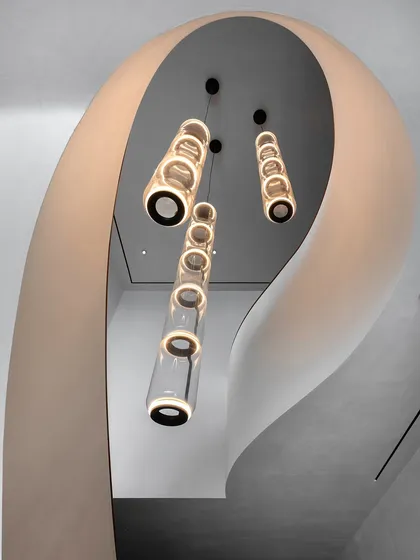 The sculptural, winding staircase in our Worli Duplex project is a central anchor that breaks the home's orthogonal geometry. We designed it not just for circulation, but as a defining artistic element, with its soft curves framing a cascade of modern lighting.