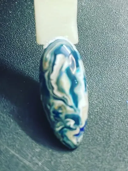 Another view of the blue and white marble effect on a sample nail tip. This abstract design is perfect for anyone wanting something artistic and unique.