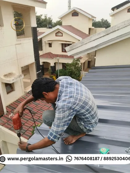 An installer carefully drills into the puff sheet roofing. This close-up shot highlights the meticulous nature of our work, ensuring every screw and seam is perfectly executed for a long-lasting finish.