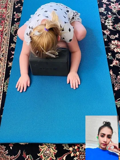 Yoga is for everyone, including kids. In this online session, I'm guiding a young student through a modified Child's Pose using a block for support. My kids' yoga classes are playful, engaging, and help build focus and body awareness from a young age.