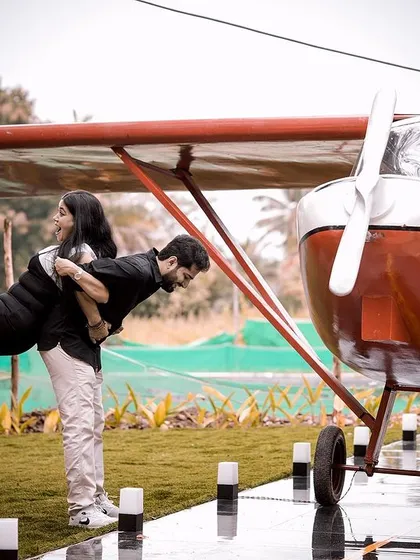 A fun, gravity-defying pose under the wing of the airplane, showcasing the playful possibilities of our props.