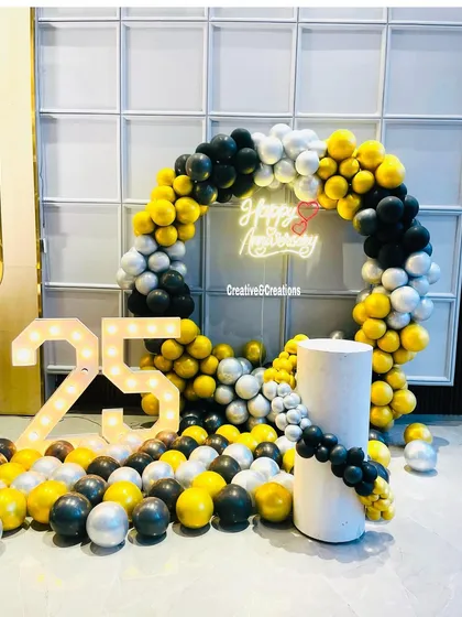 Celebrating a milestone? I design personalized decor for anniversaries and birthdays. This setup for a 25th anniversary features a custom balloon arch, a neon sign, and light-up marquee numbers for a festive and memorable party.