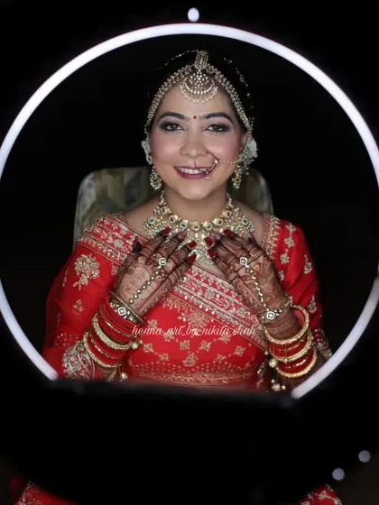 Our beautiful bride Vandana, framed by a ring light, showcasing her complete bridal look. Her happiness and stunning mehendi are what it's all about.