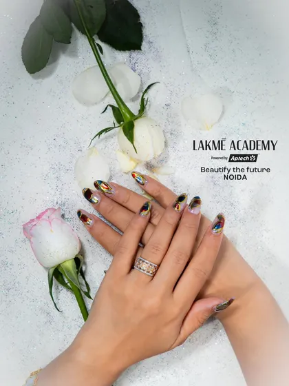 This elegant isolated chrome nail art demonstrates a sophisticated technique our students learn. We teach you how to combine metallic chrome effects with artistic patterns for a modern and luxurious look.