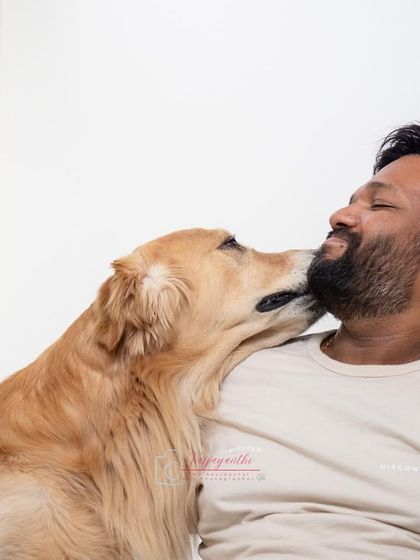 A golden retriever showing some love to his dad. These are the candid, unposed moments that become the most cherished memories.