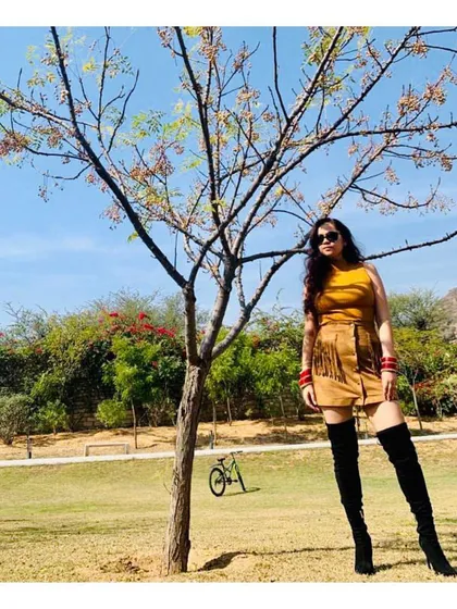 Confidence is your best accessory. Here, I've paired a suede fringe skirt with dramatic thigh-high boots for a bold, fashion-forward look. My personal shopping service helps you push your boundaries and discover styles you never thought you could pull off.