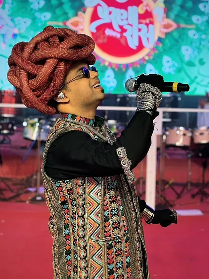 On stage, in my element, during a vibrant Navratri night. I believe an anchor's energy is contagious, and I make it my mission to keep the crowd engaged and entertained from start to finish.