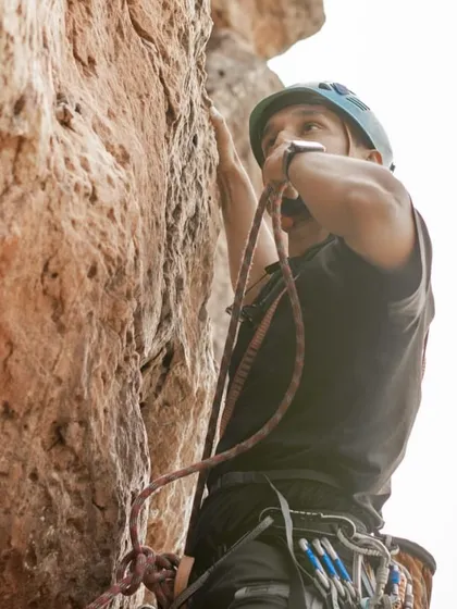 A close up of Anand belaying, fully focused on his climber's safety. This is a fundamental aspect of our community's ethos.