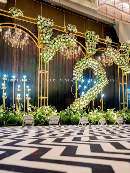 A different angle of the modern black-and-white chevron stage, offering a clearer view of the floor design and the layered floral and lighting elements. This perspective emphasizes the depth and detail of our stagecraft.