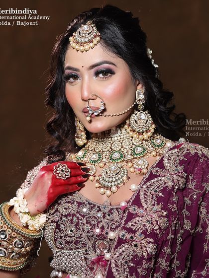A full-view portrait that captures the complete bridal look, from the heavy embroidery of the lehenga to the perfectly applied makeup.