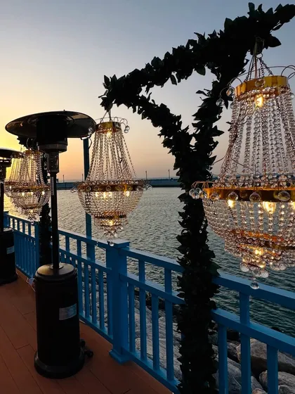 Lining the pier with chandeliers for a wedding in Doha. The warm glow of the crystals against the sunset over the water creates a gorgeous and unforgettable sight. 🤍